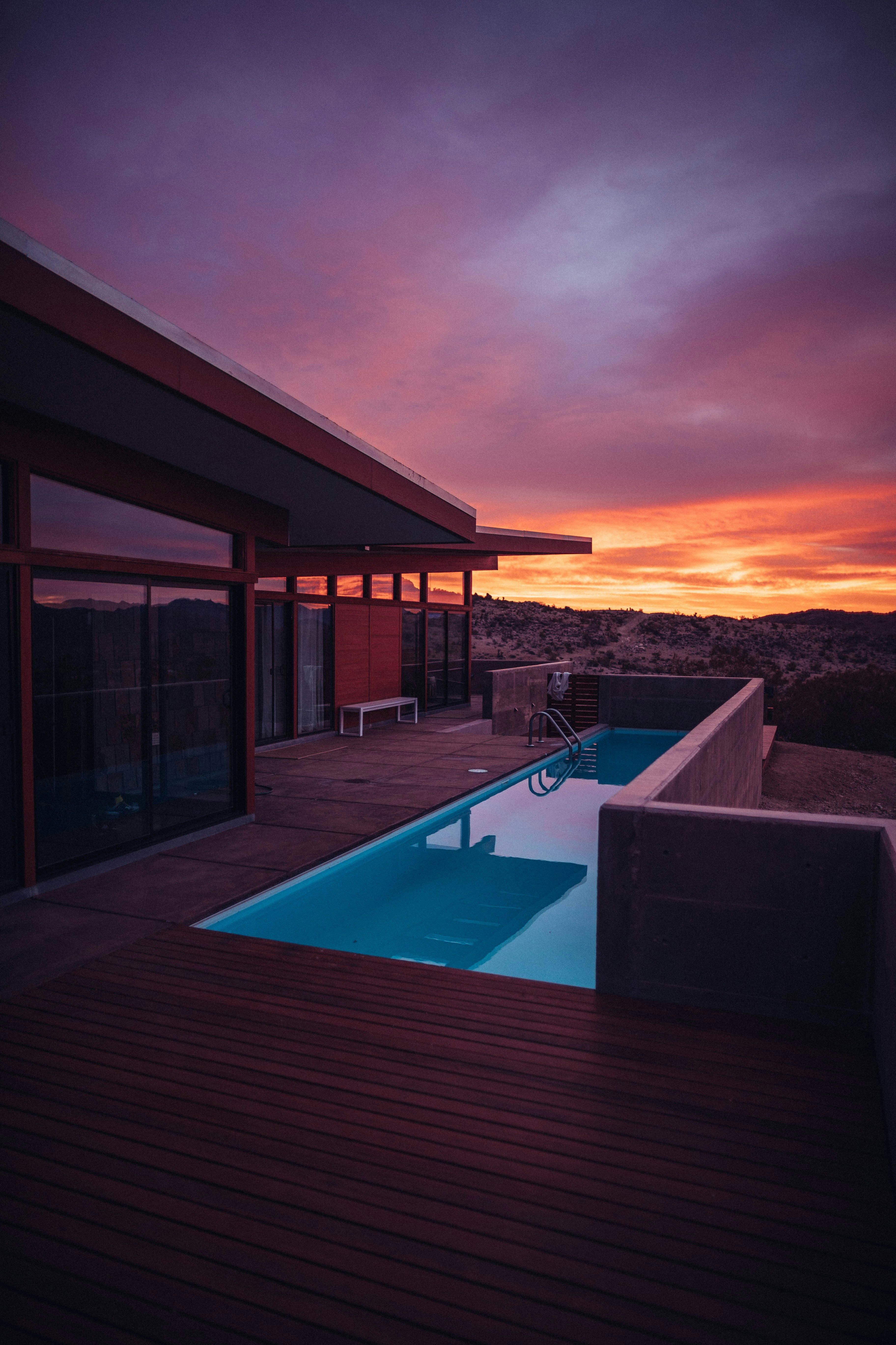 a house with a pool at sunset